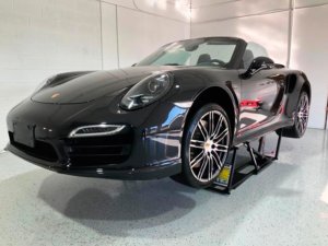 Black Porsche 911 undergoing professional paint correction at Elite Pro Car Care frontal view